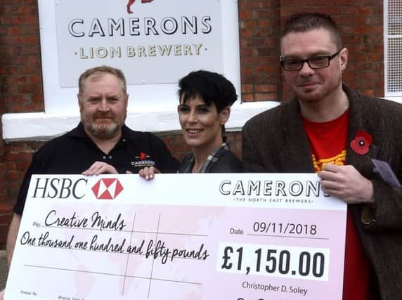 Jamie Horton and Bob Bell from Creative Minds receiving their cheque from Keith Fletcher at Camerons Brewery.