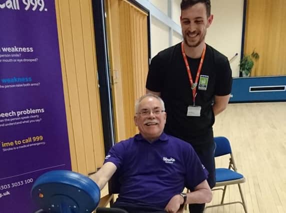 A stroke survivor learning about physiotherapy and aftercare using the MOTOmed bike at a pop up at Community Hub South.