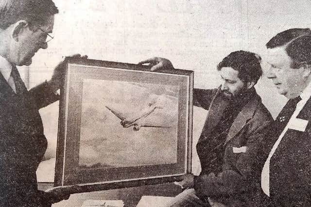 The watercolour which marked the 25th anniversary of the Greatham to London flight, including artist John Wigston, right.
