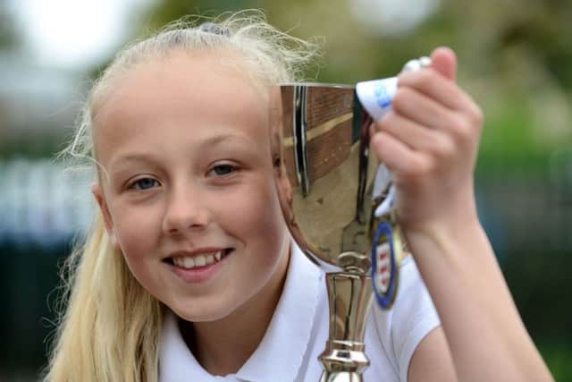Football team captain Demi-Leigh Topping with one of their trophies