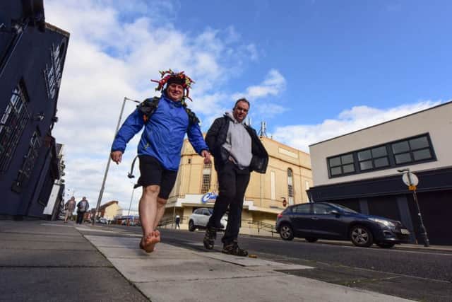 Paul Suggitt (left) walking barefoot around the town in training for a barefoot challenge he is doing next year, accompanied on Saturday by Ian Bushnell