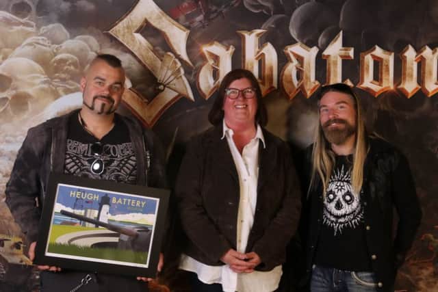 Heugh Battery Museum manager Diane Stephens with Joakim Brodén, and Pär Sundström, of band  Sabaton who raised over £4,000 for the museum.