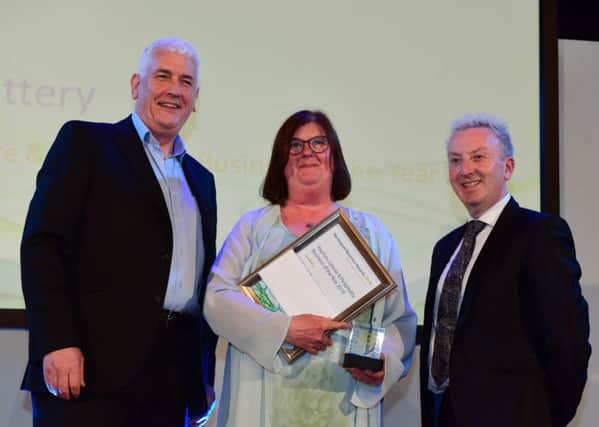 Heugh Battery manager Diane Stephens receiving the award from Hartlepool Council Leader Christopher Akers-Belcher (right) and Kevin Cranney (left) of Hartlepool Borough Council.