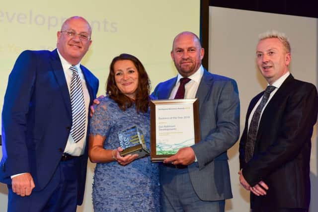 The Overall Business of the Year award went to Gus Robinson Developments Ltd. It was received by MD Stephen Bell and  Finance Director Jeanette Henderson. Presenting the award isHartlepool Council Leader Christopher Akers-Belcher (right) and Kevin Byrne (left), MD of Seymour Civil Engineering.