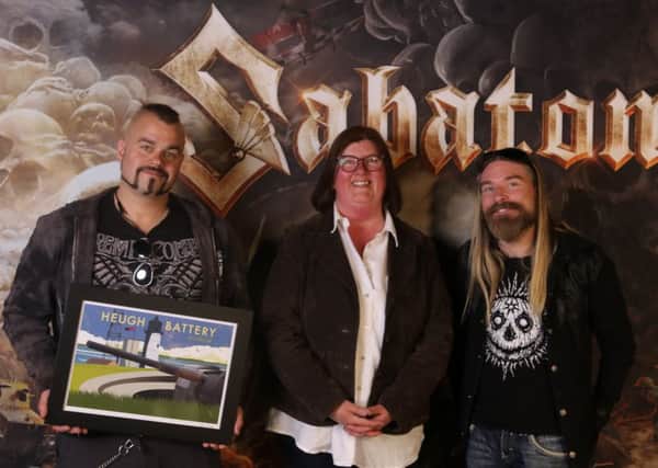 Heugh Battery Museum manager Diane Stephens with members of band  Sabaton who raised over £4,000 for the museum.