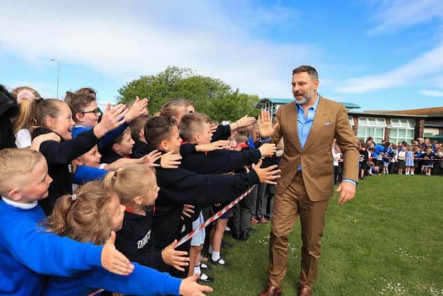 David Walliams meets the children at Flakefleet on a surprise visit. Picture: PA.