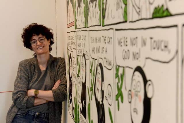 Artist Tor Freeman from London with her comic strip mural.