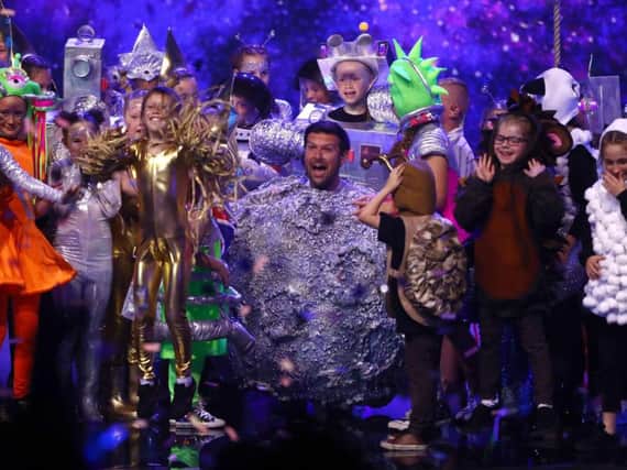 Dave McPartlin from Hartlepool on stage with his Flakefleet Primary School pupils in the final of Britain's Got Talent. Dymond/Thames/Syco/Shutterstock