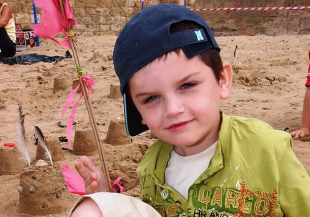 Conor Young with his sandcastle design on the Fish Sands.
