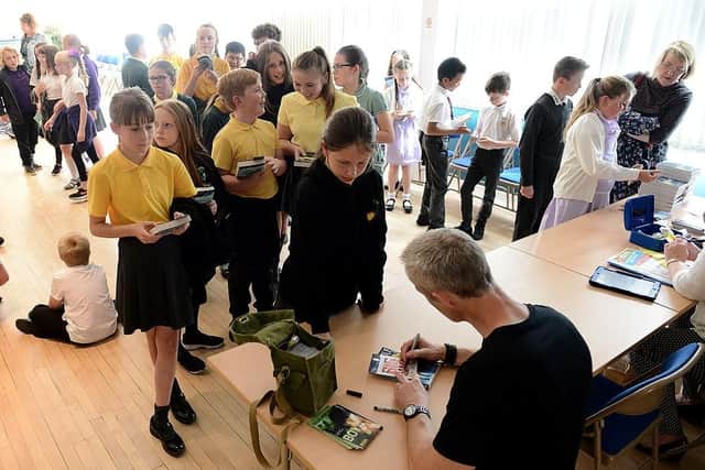 Bestselling children's author Dan Smith signs copies of his books for Fens Primary School pupils.  Picture by FRANK REID