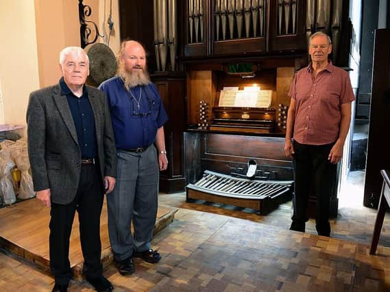 (left to right) Ian Malcolmson (organ restoration committee member) St Mary's Church, priest Fr Nick Jennings and Terry Curren (organ restoration committee member, photographed alongside of the church Organ. Picture by FRANK REID