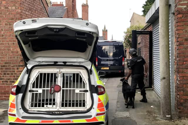 Police dog handler at the rear of the house involved in the Hutton Avenue incident.
