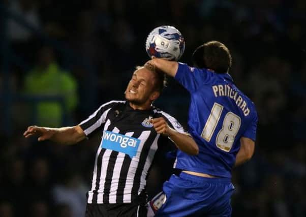 AERIAL BATTLE: Newcastle United's Siem de Jong (left) challenges for the ball in the air with Gillingham's Josh Pritchard