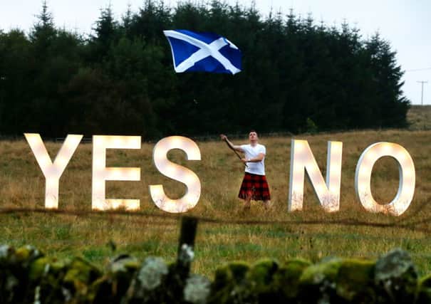 Businessman Jon Gamble from go2eventhire as he asks the question YES or NO with illuminated signs near Dunblane, Scotland, ahead of voting in the Scottish Referendum
