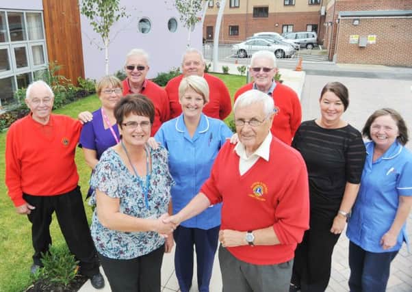 Larry Collins of Peterlee and District Lions Club with Janice Forbes of the Hartlepool and District Hospice and fellow Lions Club members and hospice staff following the cheque presentaton.