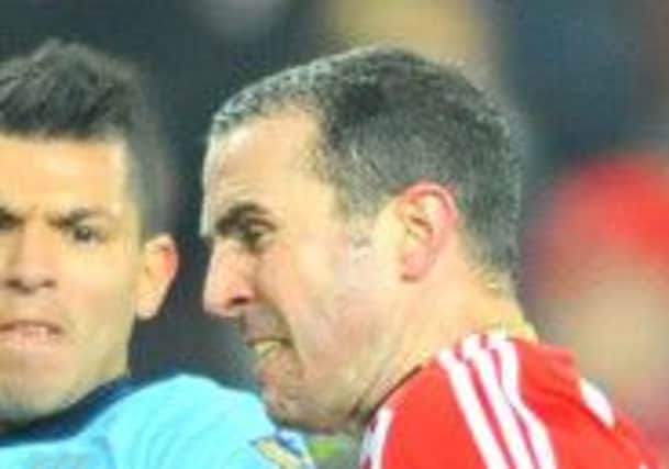 TOUGH TEST: John O'Shea in action against Manchester City. Picture by FRANK REID
