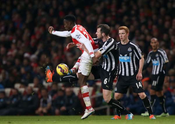Arsenal's Danny Welbeck (left) and Newcastle United's Mike Williamson (centre)