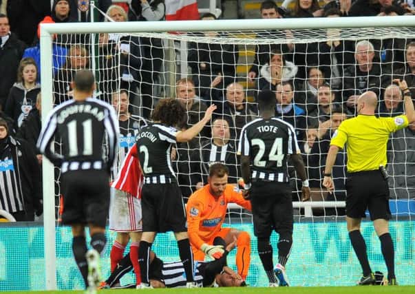 BAD COLLISION ... Steven Taylor lies prone after colliding with the goalpost.