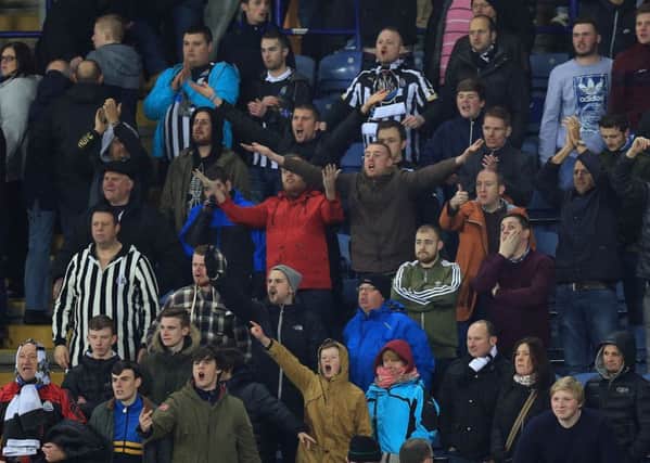 Newcastle United's fans shout abuse at their team at the end of  the FA Cup Third Round match at the King Power Stadium