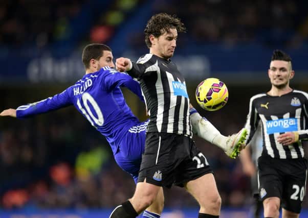 Newcastle United's Daryl Janmaat (centre) and Chelsea's Eden Hazard (left) battle for the ball