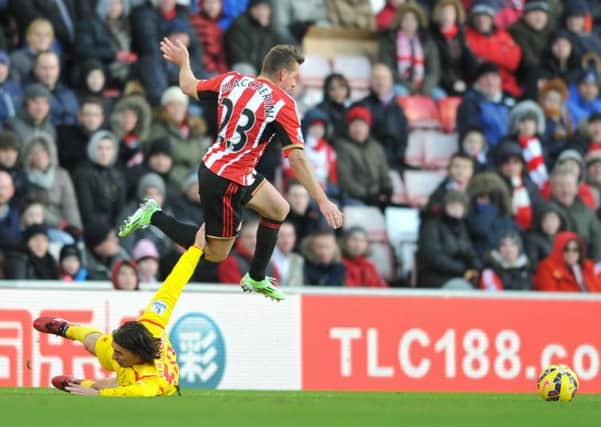Emanuele Giaccherini rides a challenge from Liverpool's Lazar Markovic