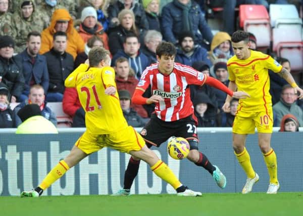 Santiago Vergini takes on Liverpool's Lucas and Coutinho in Saturday's 1-0 defeat