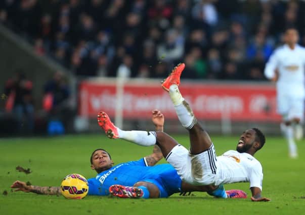 Sunderland's Patrick van Aanholt fouls Swansea City's Nathan Dyer during the Barclays Premier League match at The Liberty Stadium