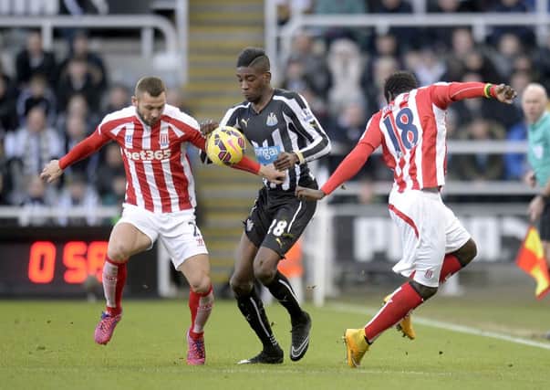 Newcastle United's Sammy Ameobi (centre) battles for the ball with Stoke City's Phil Bardsley and Mame Diouf (right)