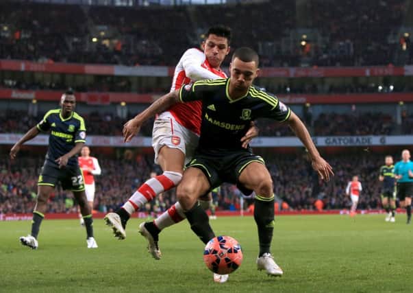 Arsenal's Alexis Sanchez battles for the ball with Middlesbrough's Ryan Fredericks (right) during the FA Cup Fifth Round match at the Emirates Stadium, London. PRESS ASSOCIATION Photo. Picture date: Sunday February 15, 2015. See PA story SOCCER Arsenal. Photo credit should read: John Walton/PA Wire. RESTRICTIONS: Editorial use only. Maximum 45 images during a match. No video emulation or promotion as 'live'. No use in games, competitions, merchandise, betting or single club/player services. No use with unofficial audio, video, data, fixtures or club/league logos.