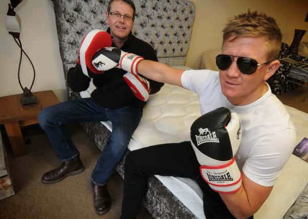 TAKING IT EASY ... FOR NOW: Boxer Bradley Saunders with Colin Rafferty from the Sofa Bed Store