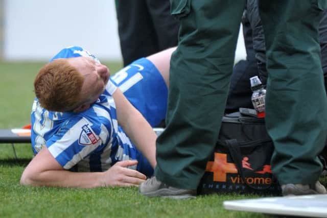 Michael Woods is given attention on the Victoria Park pitch.  Picture by FRANK REID