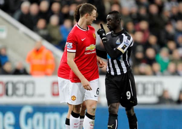 altercation ... Papiss Cisse and Jonny Evans during Wednesday nights game.