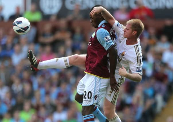 Alan Tate (right) in action against Aston Villa's Christian Benteke in the Barclays Premier League