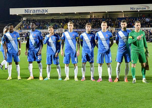 Hartlepool United's players line-up wearing their yellow armbands