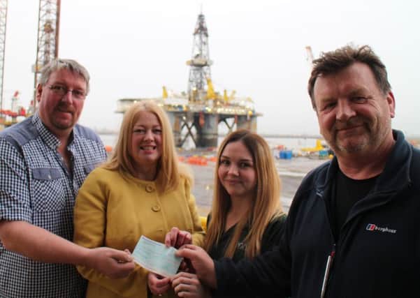 Receiving the cheque is Victoria Rogers (second left) from Zoes Place, with, Paul Connally (Able Project Manager), Zoe Ritchie (Stewardess on the WilPhoenix )and Brian Taylor (Offshore Installation Manager with the WilPhoenix).