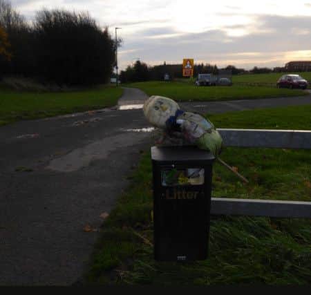 The overflowing litter bin photographed by Mitch Wilson in November by the A179