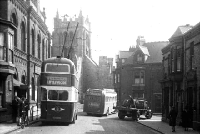 A busy scene at Durham Street, where a trolleybus is parked outside St Hilda's Hall and a Camerons Brewery lorry is unloading barrels of beer to the Cosmopolitan pub.