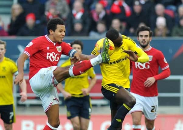 Bristol City's Korey Smith clashes with  Middlesbrough's Albert Adomah