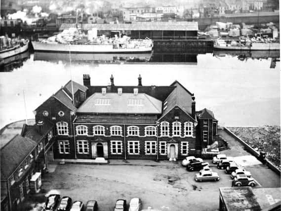 The shipyard offices opposite some of the ships in Swainson Dock from the mothball fleet. At the top of the picture is West Hartlepool railway station and beyond is Church Street.