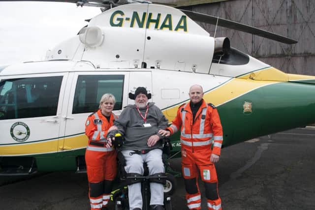 Roger Farwell, centre, with paramedics Jane Peacock, left, and Colin Clark.