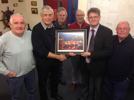 Hartlepool RNLI volunteer Alastair Rae has retired from his position as Lifeboat Administration Officer after 20 years service.
 Alastair (right) receives a photograph of the Hartlepool Lifeboat.