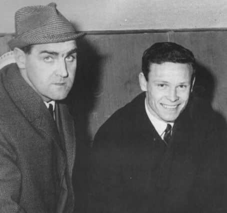 Bobby Cummings signs on under the watchful eye of manager Gus McLean. Cummings' goals would help Pools to promotion.