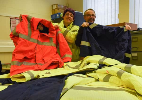 Gary Watson from Cape Engineering hands over safety clothing to Kelly Robson, of Approach Training Safely.