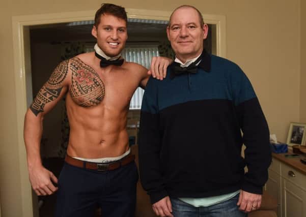 Topless waiter Chris Richardson with MS sufferer Eric Thomson.