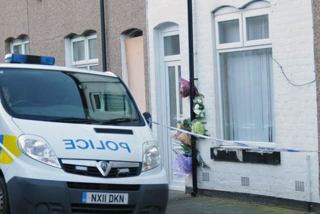 Flowers left outside the scene following the death of Angela Wrightson.