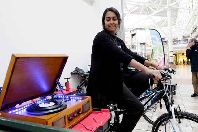 Get Cycling staff member Rebekah Uddin powers the record player as she pedals. Picture by FRANK REID