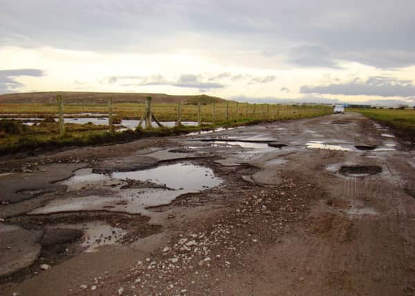 Potholes on the road to North Gare car park.
