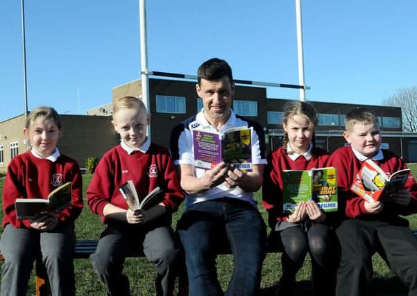 Author Tom Palmer reading one of his books with West View Primary school pupils (left to right) Katie Douglas, Rhys Blackwood, Katie Reid and Alex Griffin . Picture by FRANK REID