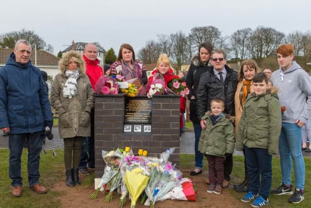 Family, friends and relatives attend the unveiling of a memorial to the three fishermen who were lost in the Firth of Forth.