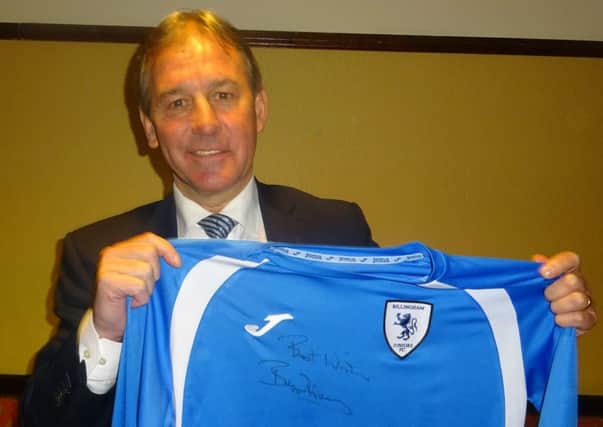 Bryan Robson with one of the signed shirts to be auctioned off.